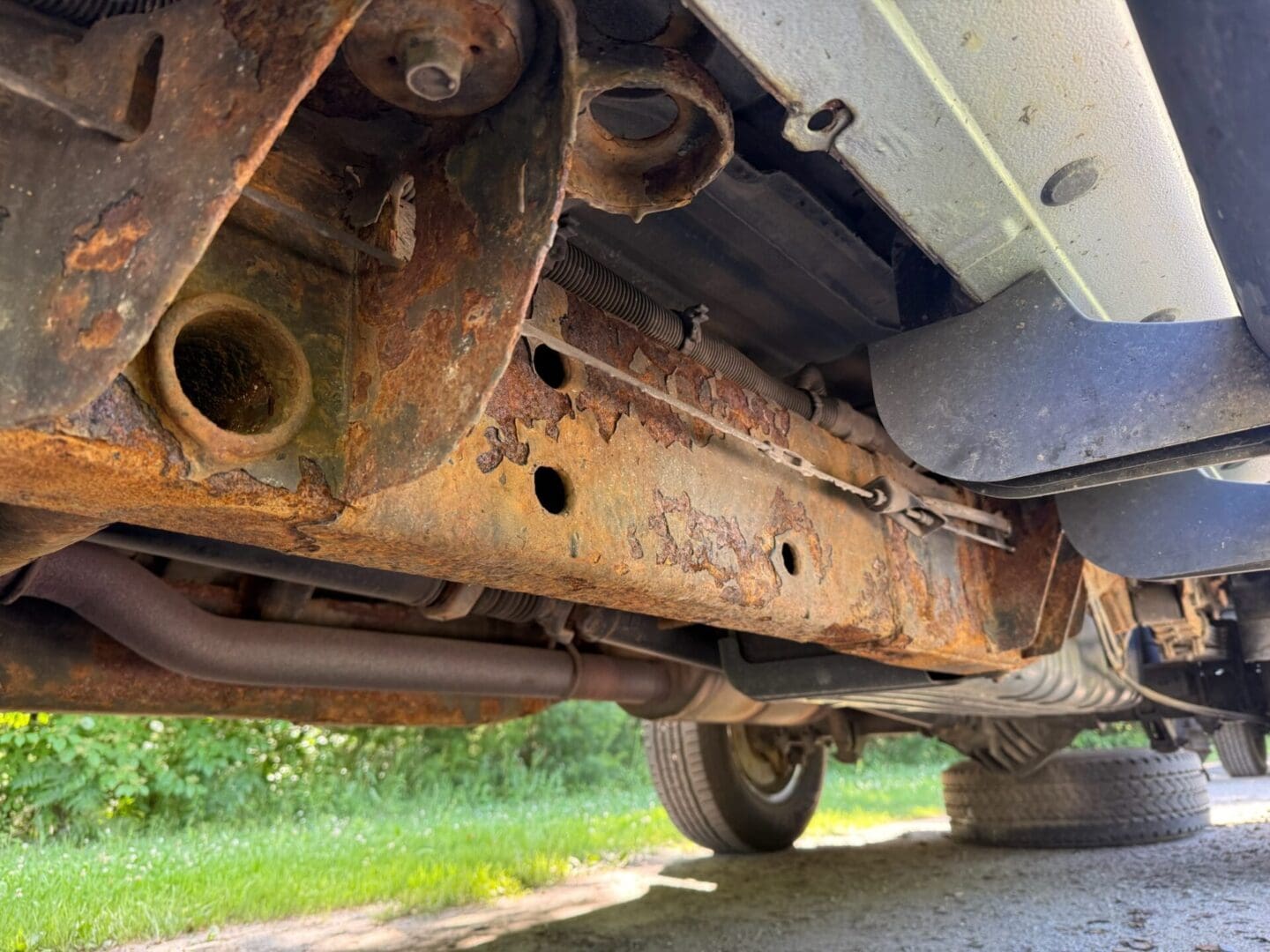 rusted frame before fluid film rust protection undercoating